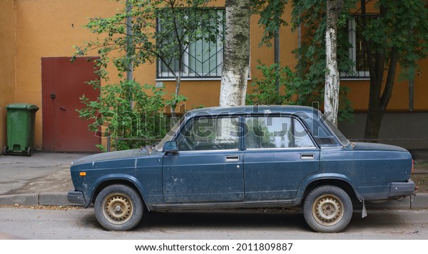 An old\
blue Soviet car in the courtyard of a residential building, Dybenko\
Street, St. Petersburg, Russia, July\
2021