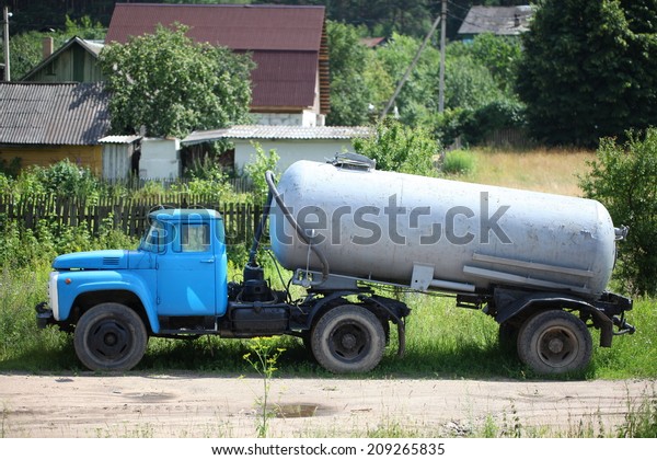 old blue truck with Tank Semi Trailer.Belarus,\
Minsk, July 20, 2014