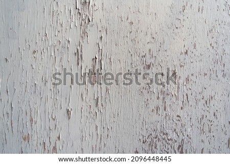 old board with pealing white paint
