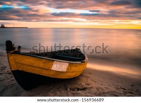 Old boat at beach during sunset 