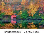 An old boat house at the lake at DeSoto Falls during peak fall colors.