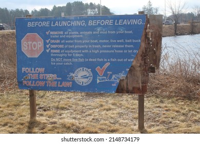 An Old  Boat Launch Sign By A Boat Ramp In A Park