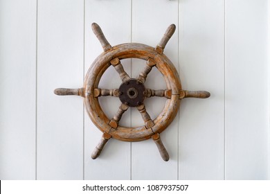 Old Boat Steering Wheel Mounted On The White Wall