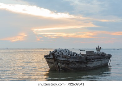 old boat from wood in the sea light sunset