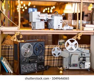 Old bobbin tape recorder and film projector on the shelf - Shutterstock ID 1049646065