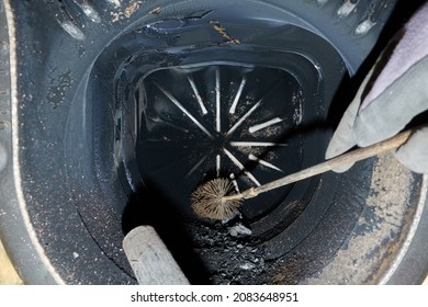 Old Boiler With Soot And Combustion Residues. After-sales Service With Brush And Vacuum Cleaner For A Clean And Environmentally Friendly Operation.