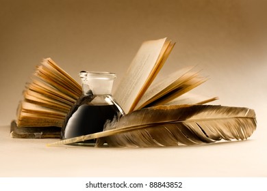 An old book with a feather and the inkpot full of ink - Powered by Shutterstock