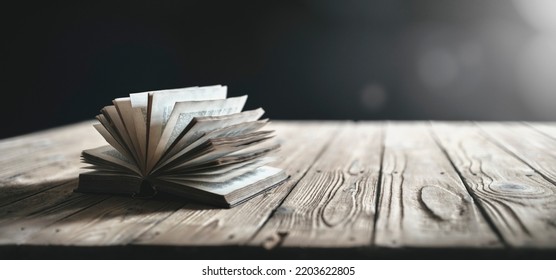 Old book or Holy Bible background open on a table with spot light - Shutterstock ID 2203622805