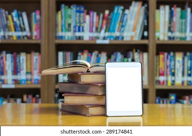 Old Book On The Desk In Library With Tablet