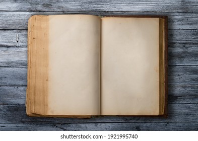 old book open on a wooden table - Shutterstock ID 1921995740