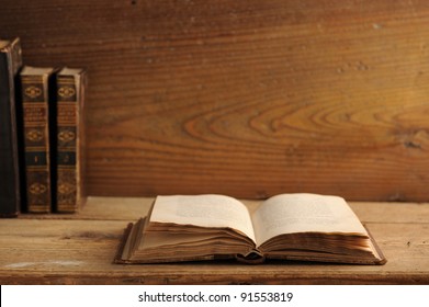 Old Book Open On A Wooden Table