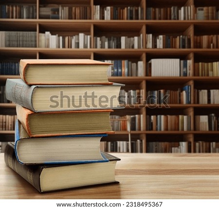 Old Book stack on the desk in public library room background