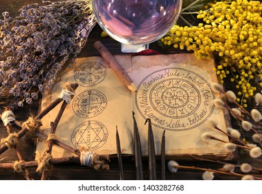 Old Book With Wiccan Holidays Chart, Pentagram, Crystal Ball And Herbs. Wicca, Esoteric, Divination And Occult Background With Vintage Magic Objects For Mystic Rituals