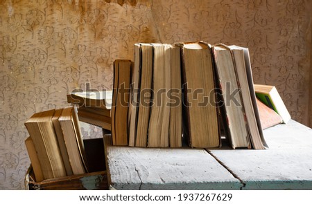 old books abandoned on an old wooden table