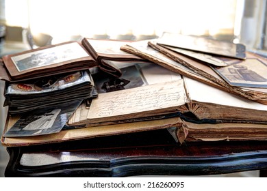Old books, albums and photos on antique table. - Shutterstock ID 216260095