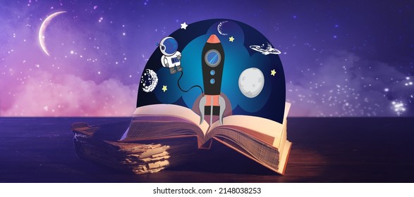 Old Books With Drawn Spaceship On Table Against Sky At Night