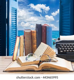 Old Books, Glasses And Typewriter Over Open Window To Sea And Sky Background - Writting And Publishing Concept