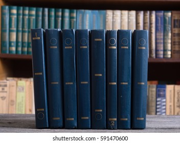 Old books in the Library on wooden background