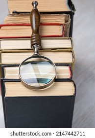 Old Books And Magnifying Glass On Table, Abstract Background. Concept Of Search, Mystery, Detective, Love Of Reading, Learning New Knowledge. World Book And Copyright Day, 23 April