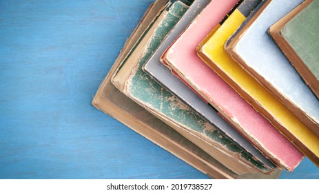 Old books on the blue wooden background. - Shutterstock ID 2019738527