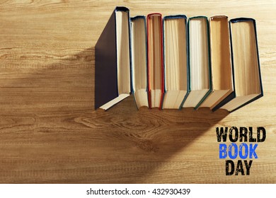Old books on wooden table, top view. World Book Day poster
