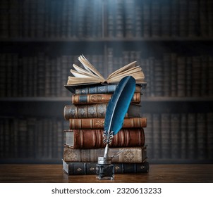 Old books ,quill pen and vintage inkwell on wooden desk in old library. Ancient books historical background. Retro style. Conceptual background on history, education, literature topics.