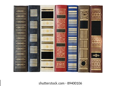 Old books in a row. Isolated over white.