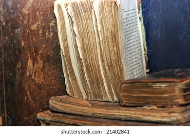 Old Books With Torn Edges Lying On The Dusty Shelf