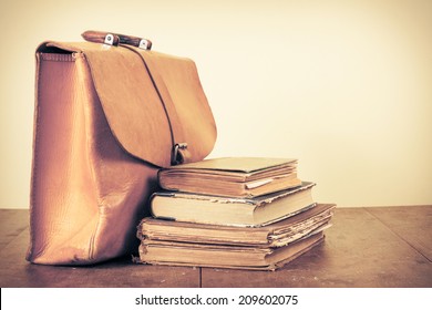 Old Books And Vintage Leather School Bag On Table