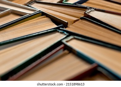 Old books with yellow pages bound together by colorful covers. Abstrack background