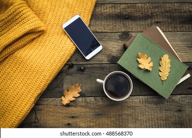 Old book,smart phone , autumn leaves  on wooden background. Concept autumn. Top view   - Powered by Shutterstock