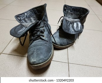 old boots or old boots stand on the flooring