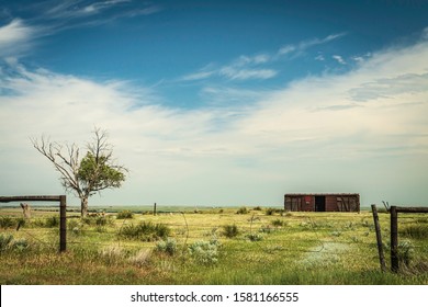 Old Boxcar In Farm Field With Fence