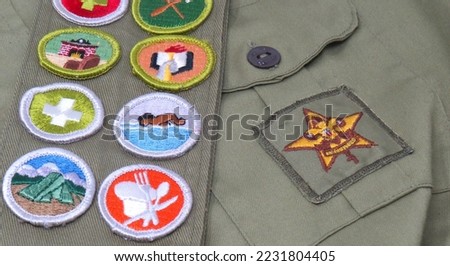 Old Boy Scout Uniform with Star Symbol and Colorful Merit Badge Sash.