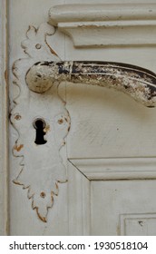 Old Brass Doorknob On A White Door Close-up
