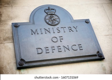Old brass sign marking the offices of the British Ministry of Defence on a building in Whitehall, London, UK