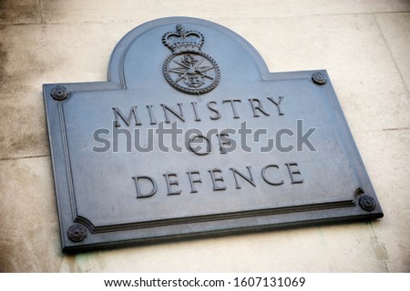 Old brass sign marking the offices of the British Ministry of Defence on a building in Whitehall, London, UK