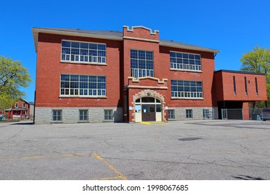 An Old Brick Abandoned School With Advertisement Space.