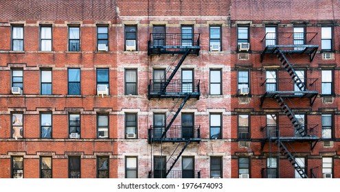 Old brick apartment buildings with windows and fire escapes along Second Avenue in the Upper West Side of Manhattan, New York City NYC 