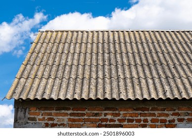 An old brick barn in the Polish countryside with a corrugated asbestos roof. - Powered by Shutterstock