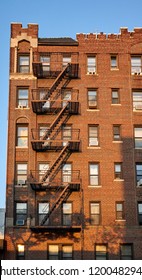 Old Brick Building With Fire Escapes At Sunset, New York City, USA.