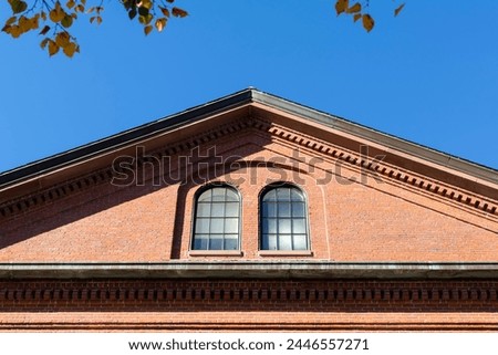 Old brick building gable end with fixed arched windows in Watertown, MA, USA