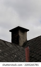 Old Brick Chimney On A Background Of The Cloudy Sky