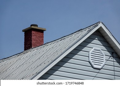 An old brick chimney on a blue sky
