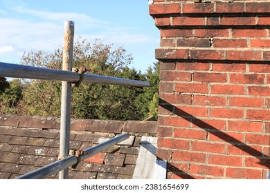 Old brick chimney stack in need of repointing