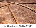 Old brick coffee drying yard with rails on a historic Brazilian farm. A glimpse into the traditional methods and infrastructure of coffee production that shaped Brazil