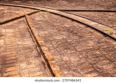 Old brick coffee drying yard with rails on a historic Brazilian farm. A glimpse into the traditional methods and infrastructure of coffee production that shaped Brazil's economy and history.