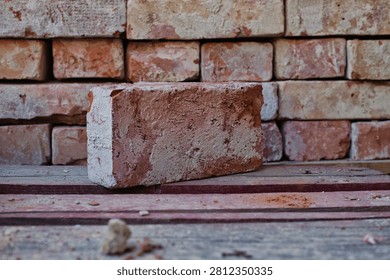 Old brick infront of pile of bricks
