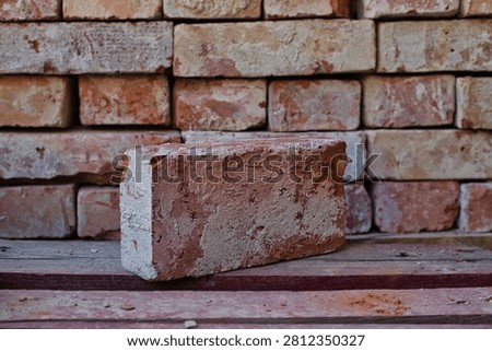 Old brick infront of pile of bricks