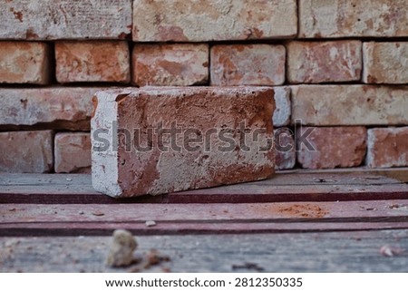 Old brick infront of pile of bricks